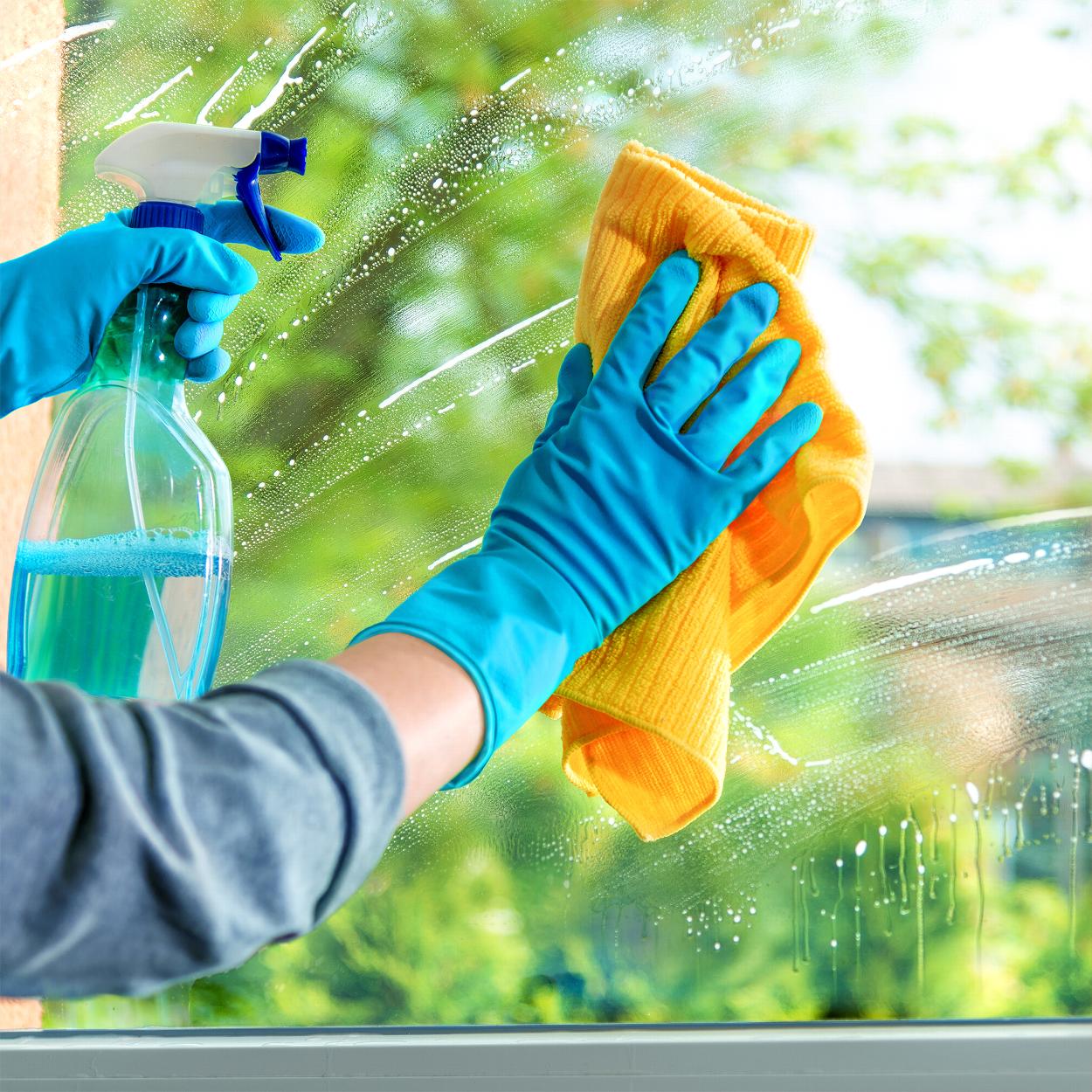 Cleaning windows with spray bottle
